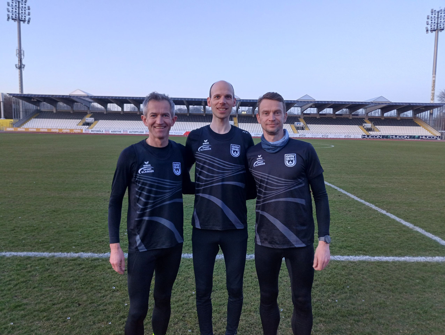 Drei Läufer des SSV 1846 in Trainingsshirts auf Stadionrasen