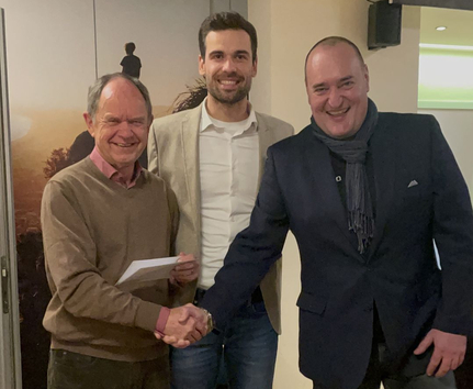 Ehrung Dimitriy Mironov (re.) 25 Jahre Mitarbeit SSV Ulm 1846 e.V. – Dimitriy Mironov (re.) mit Geschäftsführer Fabian Göggel und Vereinspräsident Willy Götz. Drei Männer lächelnd bei Mitarbeiterehrung, Handschlag und Dokument