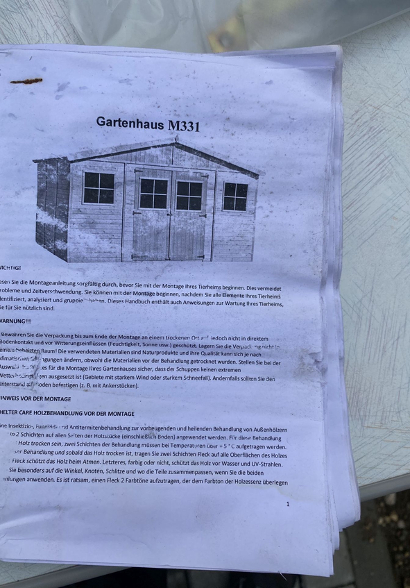 Anleitungspapier mit Überschrift Gartenhaus M331 und Schuppenillustration