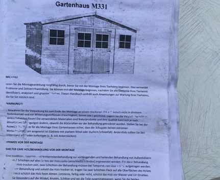Anleitungspapier mit Überschrift Gartenhaus M331 und Schuppenillustration