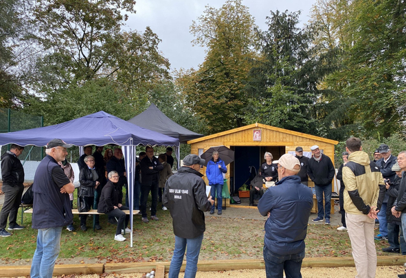 Gruppe Menschen bei Holzhütte und Pavillon beim Boulespiel SSV ULM 1846 BOULE