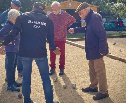 Seniorinnen und Senioren diskutieren Kugelpositionen auf Boulebahn Ssv Ulm 1846 Boule
