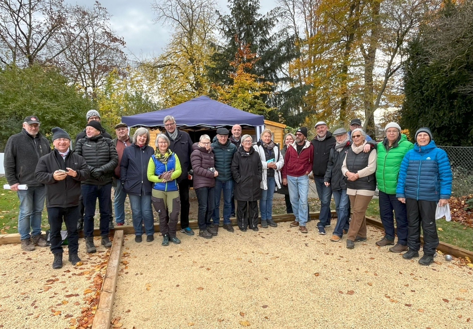 Gruppe von etwa 22 Personen auf Bouleplatz vor Pavillon